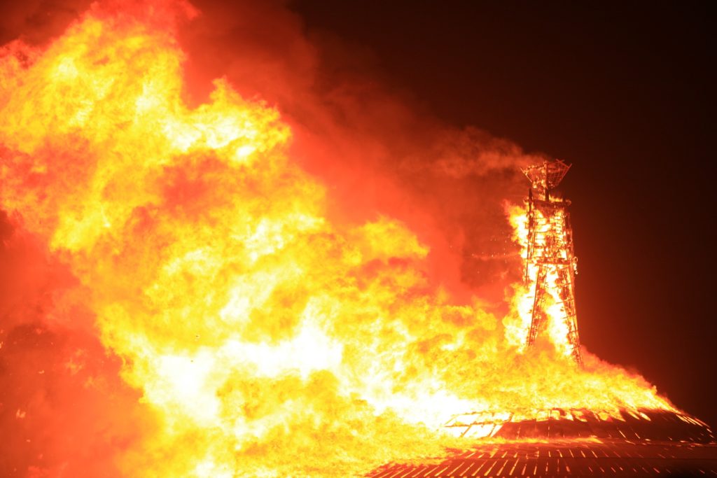 The Man burning with massive flames reaching toward
the night sky.
