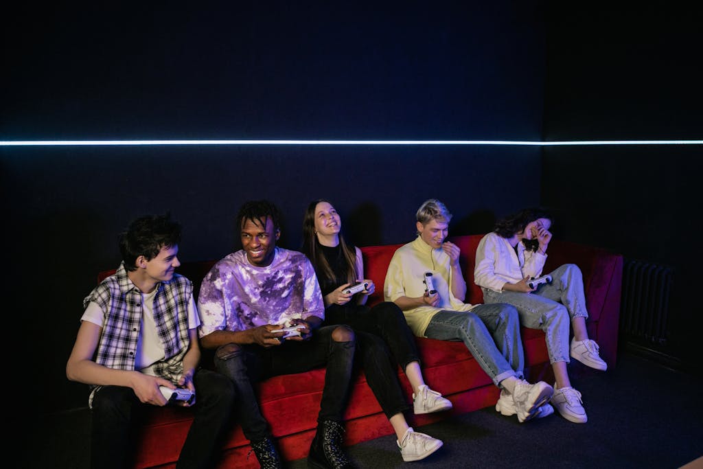 A diverse group of friends enjoying video games, laughing and having fun indoors.