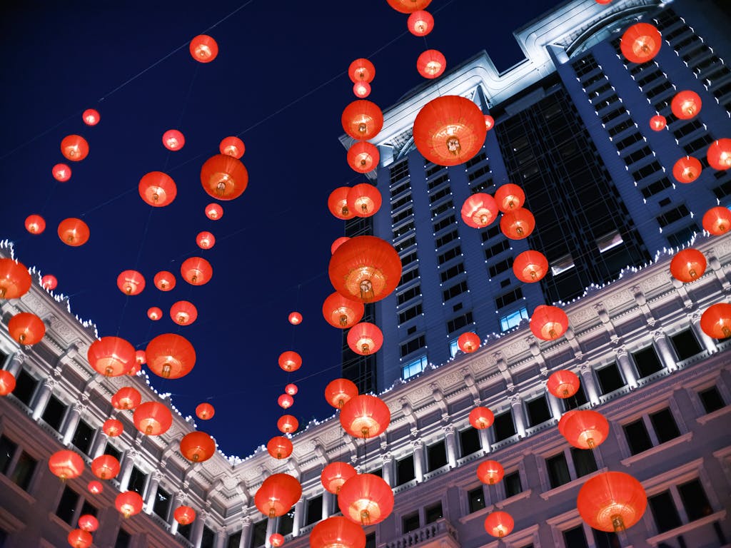 A stunning view of red lanterns hanging in Kowloon, Hong Kong against a dark sky.