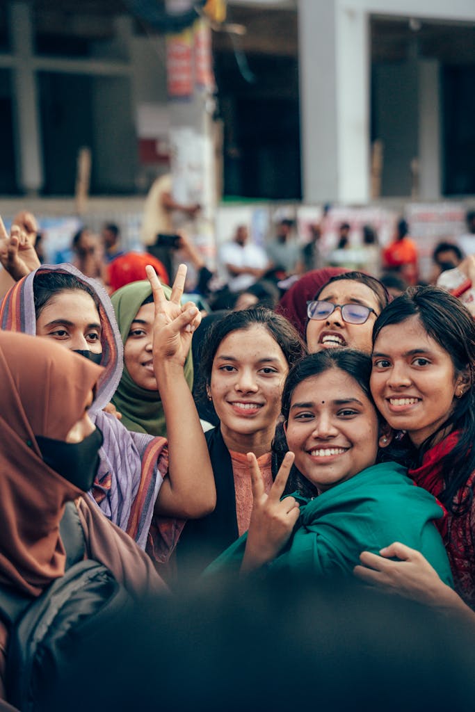 Group of women celebrating on the streets of Cumilla, Bangladesh, showcasing vibrant expressions and joy.