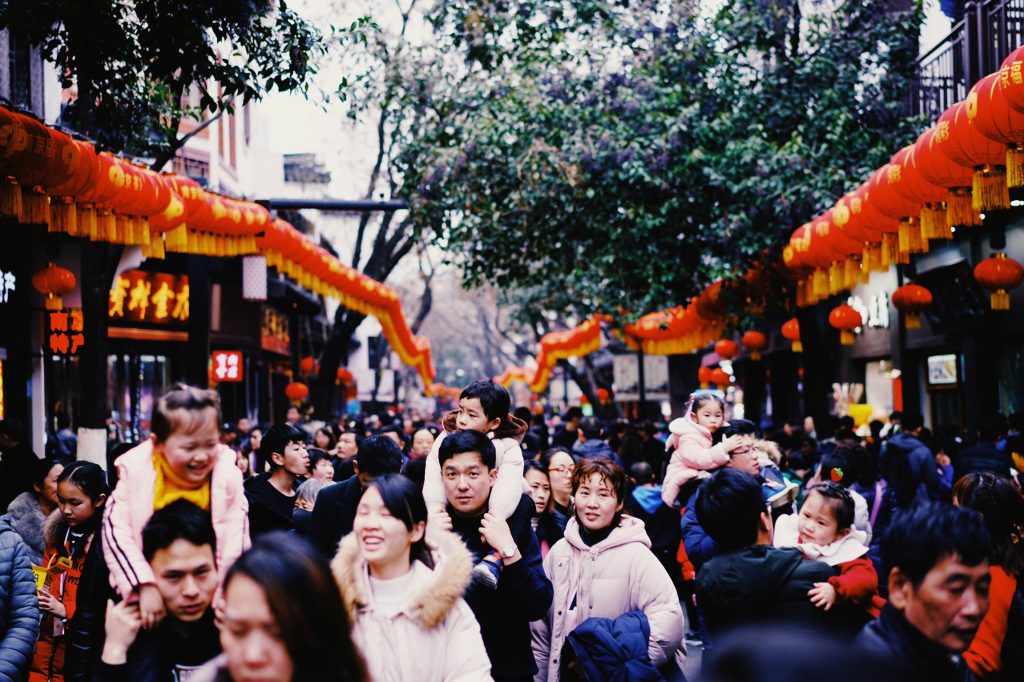Asian people with families and children celebrating a festival in the streets with Chinese-style decorations