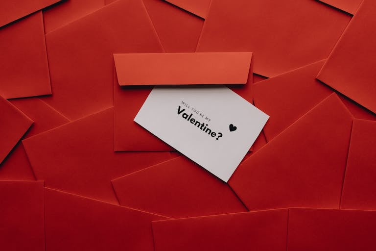 Stylish Valentine’s greeting card surrounded by red envelopes. Perfect for love and romance themes.