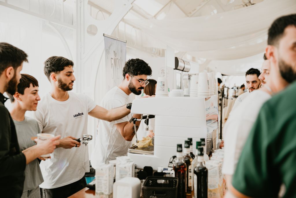 Attendees enjoy coffee at a lively coffee stand during an event in Baku, Azerbaijan.