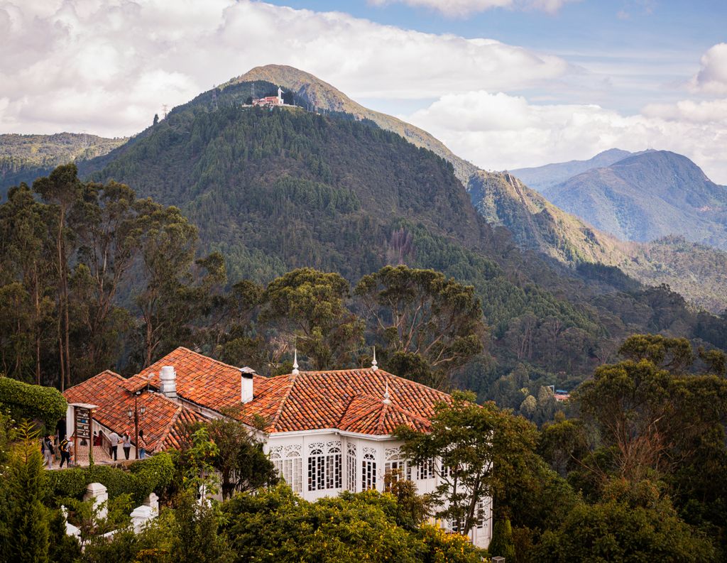 Picturesque view of lush mountains and traditional house in Bogotá, Colombia.